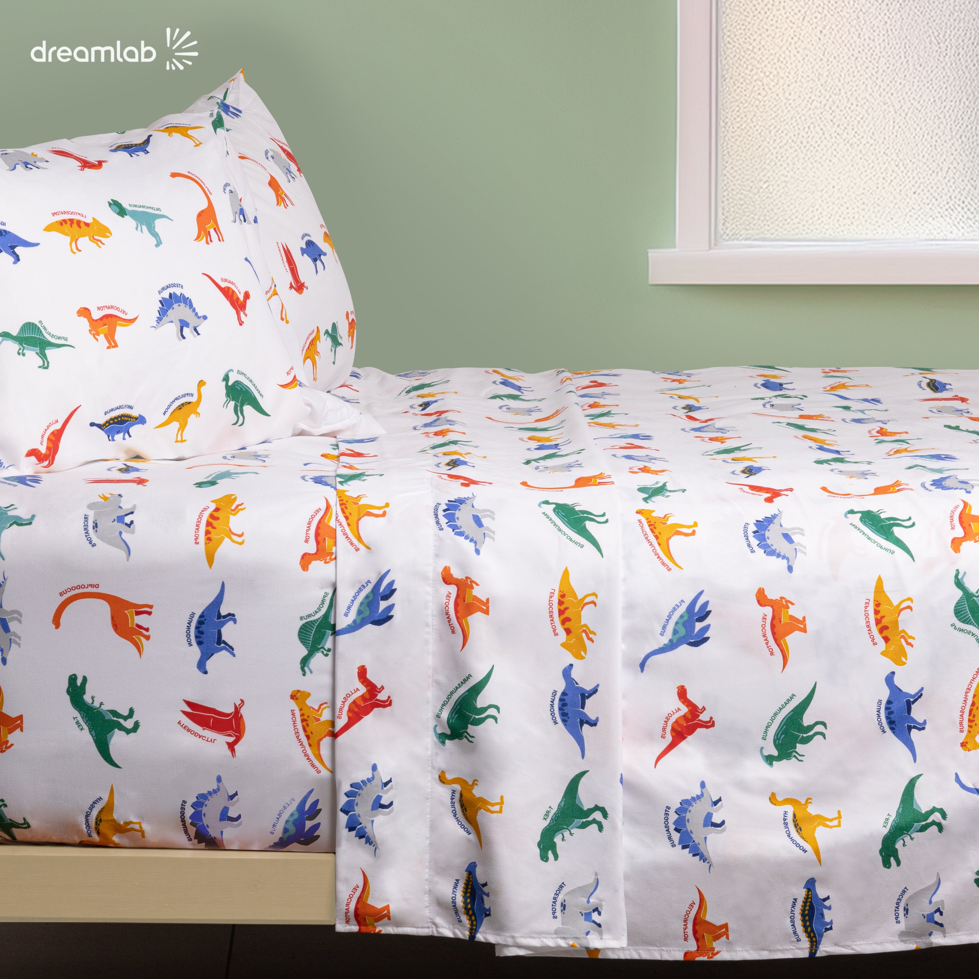 Sábanas Dreamlab infantiles con diseño de dinosaurios, estampadas, hipoalergénicas y suaves, perfectas para la habitación de los niños.